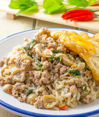 pork fried rice and fried egg with basil and chili background