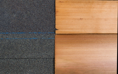 New shingles of composite and cedar wood side by side to compare