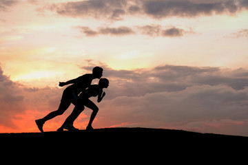 Silhouette of sportsmen ready to start.
