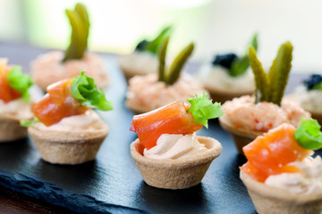 Mini puff pastry tart lets with smoked salmon filling.