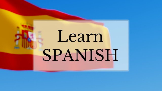 Learn Spanish text w/ Spanish flag background. Learn Spanish language concept
