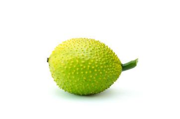 Gac fruit green and yellow on a white background