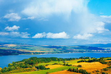 Fototapeta na wymiar Beautiful landscape, yellow meadow and lake in background
