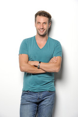 A handsome mature man smiling at the camera against a white background