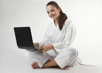 Attractive young sexy women in a karate pose with notebook