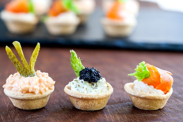 Variety of savory mini pastry tartlets.
