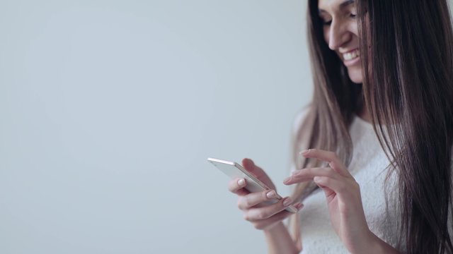 Girl written on a phone and smiling