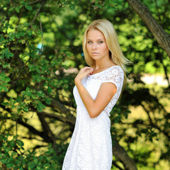 Fototapeta premium Portrait of a beautiful pretty girl in summer park