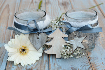 Old wooden grey shelves with white Christmas  wooden decoration and candles holder decorated with gerber daisy flowers