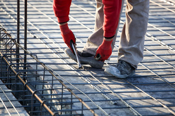 workers make reinforcement for concrete foundation