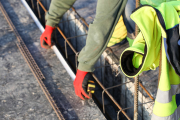 workers make reinforcement for concrete foundation