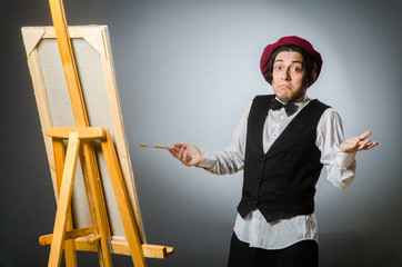 Funny artist in dark studio