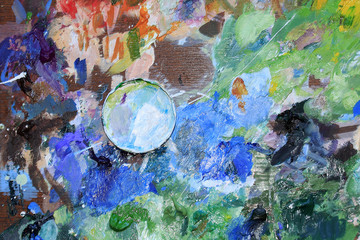The Cup on the palette for mixing of the paints