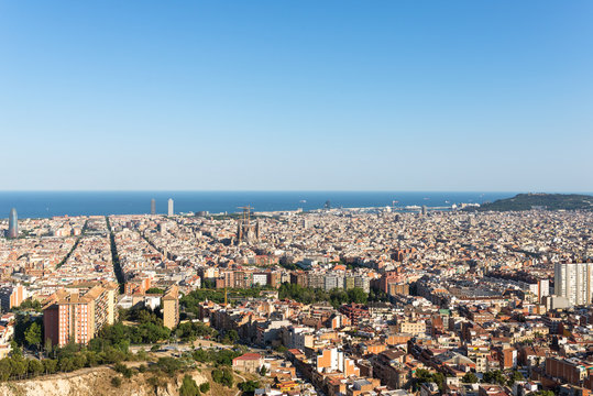 The Torre Agbar in the Barcelona district Poblenou. The Sagrada Familia in the district Eixample. In the middle, in the background, the towers of the Port Olimpic, the harbor and the mount Montjuic
