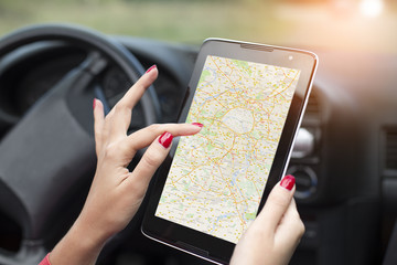 women using gps on tablet computer to navigate in car.