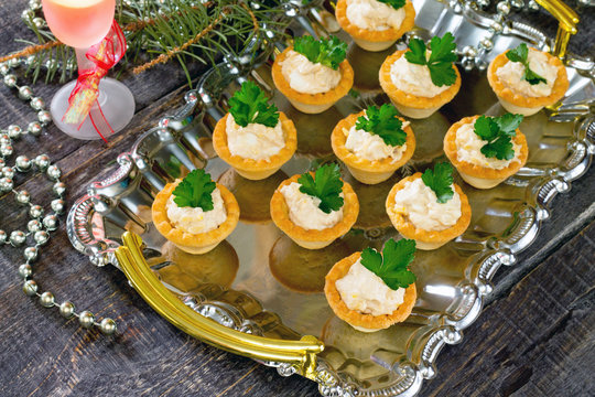Tartlets with cod liver mousse on New Year's Eve, selective focu