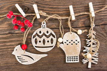 Wooden christmas decoration hanging on wooden background