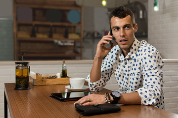 Businessman in a cafe talking on the phone