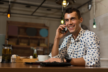 Businessman in a cafe talking on the phone
