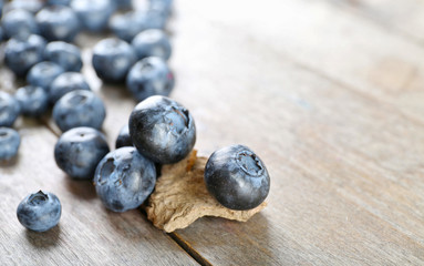 Tasty ripe blueberries on wooden table close up