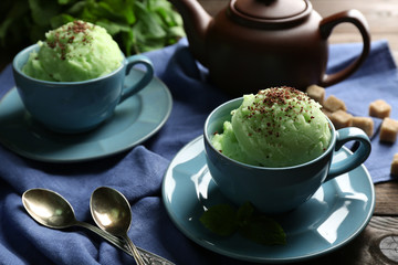 Homemade Green tea ice-cream in cup, on wooden background