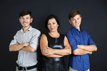 Portrait of mother and her sons on dark background