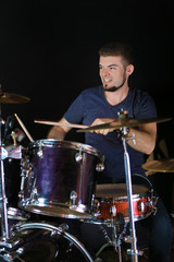 Drummer on dark background