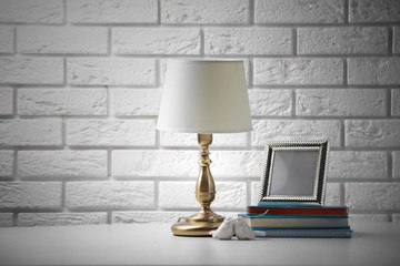 Old fashion table lamp on table on brick wall background