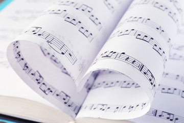 Naklejka premium Book pages curved into heart shape close up