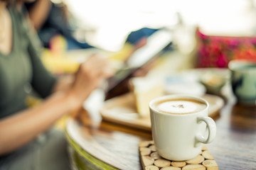 Woman using a tablet during a coffee break