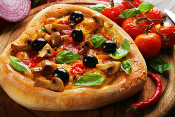 Heart shaped pizza served on wooden table, closeup