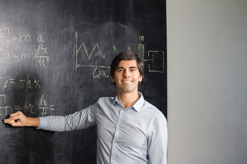 Teacher showing formulas on the blackboard