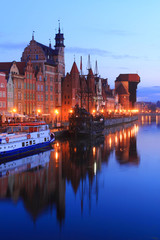 Fototapeta na wymiar Famous Old Town of Gdansk at Motlawa River with medieval crane building at the dusk. Poland