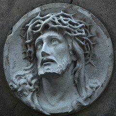 Jesus Christ statue against a background of gray stone