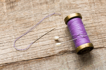purple needle and thread