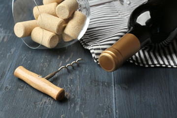 Fototapeta na wymiar Bottle of wine and corks on wooden table