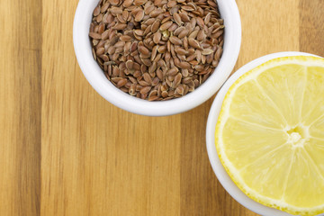 Lemon and linseeds on wooden background