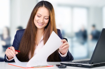 Portrait of beautiful business woman working in her office.