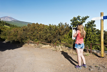 Fototapeta na wymiar Young girl taking photo in Teide national Park