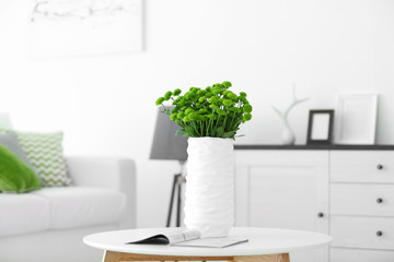 Beautiful green chrysanthemums in vase on table in room