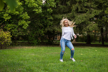 Fototapeta premium young attractive girl in a hat sunny summer day in the park