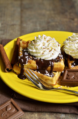 Homemade waffles with chocolate and whipped cream.