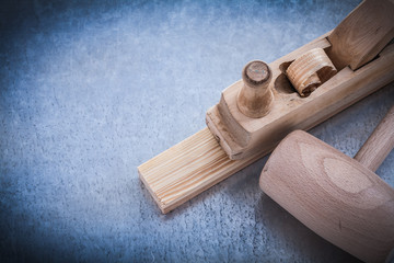 Planer lump hammer wooden stud on metallic background constructi