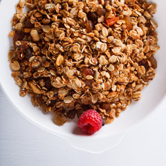 Homemade granola with fresh berries and honey.