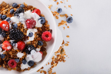 Homemade granola with fresh berries and honey.