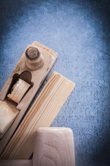 Wooden shaving plane mallet brick on scratched metallic surface