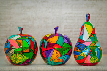 Decorative multi-colored apples and pears. Contemporary art, decorative fruit made of wood, hand...