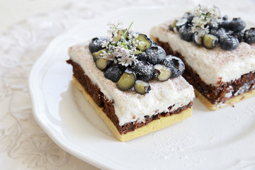 Classic Chester Cake slices with blueberries and Cilantro flower