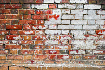 Old brick wall with big white spot of old paint, place for text, copyspace