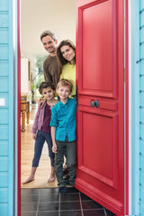 family is opening their stylish red door to welcome the guest